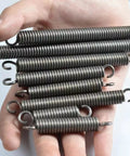 Heavy Duty Dual Hook Tension Springs Made From Spring Steel That Are Just The Right Size At 3.5mm Wire And 18M Outer Diameter held in hand.
