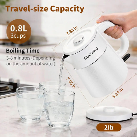 Grab And Go Travel Ready Electric Kettle 0.8L pouring water into glass, showing white double-wall design, on countertop.
