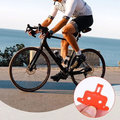 Cyclist with close-up of 6 Piece Bike Disc Brake Spacer Set With Piston Reset And Pad Separation Tools Durable Orange Plastic Spacers