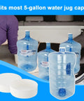 Six Pack Of 53Mm Screw On Water Bottle Caps With Foam Lined Leak Free Seal For 5 Gallon Jugs Rock Solid Replacement Lids 53 400 Thread Size Easy Change White shown with 5-gallon water jugs in background.