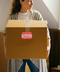 Person holding box with Fragile Red Shipping Labels With High Visibility And Strong Adhesive, Paper Warning Stickers