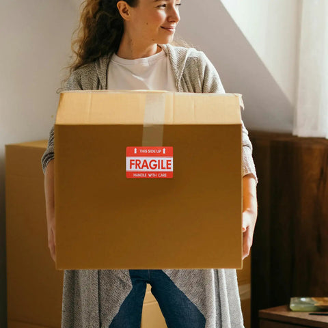 Person holding box with Fragile Red Shipping Labels With High Visibility And Strong Adhesive, Paper Warning Stickers