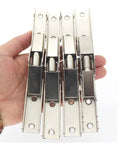 Set of four Sleek Invisible Concealed Hydraulic Buffer Cabinet Hinges for effortless quiet closing and space saving design in hand