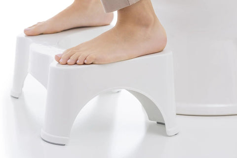 Person using Original Bathroom Toilet Stool Set With 7 And 9 Inch Heights In White Doctor Recommended For Natural Squat Posture