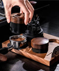 Top Shelf Wood Tamper For Espresso Makers Featuring Spring Loaded Calibration For 51mm 54mm And 58mm Portafilters in use with a filter basket.