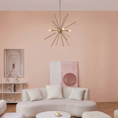 Novogratz Celeste 4 Light Chandelier in Matte Brass Dope Modern Glam Ceiling Fixture with Open Frame Design in a living room