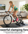 Indoor training setup with rider on a bike and Rapid Dope Quick Release Wheel Skewer for trainers, living room setting.