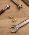 Brass Furniture Stabilizer Legs Four Pack For Mini Cabinets And Desks 10mm Decorative Riser Feet next to tools on a wooden surface