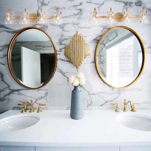 Gold Modern Bathroom Vanity Lights Over Mirror With Four Clear Glass Shades above dual mirrors in luxurious bathroom