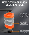 Glasses cleaning tool with orange cap and stacked gray microfiber cloth discs (close-up view)