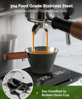 Stainless Steel Espresso Measuring Cup With Wide Mouth And V Shaped Pour Spout, Easy Grip Handle, Built In Scale For Latte Cappuccino Americano Macchiato, Pro Grade For Home Baristas Black collecting espresso from machine.