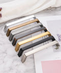 8-color variety of cabinet pulls on marble surface, showcasing 10 Pack 5 Inch Hole Centers Brushed Nickel Cabinet Pulls Zinc Alloy Hardware