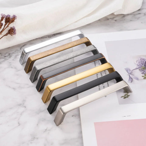 8-color variety of cabinet pulls on marble surface, showcasing 10 Pack 5 Inch Hole Centers Brushed Nickel Cabinet Pulls Zinc Alloy Hardware