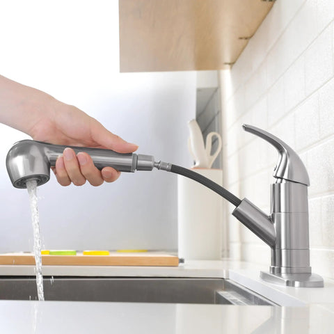 Slick Pullout Kitchen Faucet With Brushed Nickel Stainless Steel Single Handle Compact Design And Dual Spray Modes showing hand using spray head.
