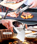Close-up of All In One 45 Piece Griddle Accessories Kit for Flat Top Grills with tongs and spatula in use during barbecue.