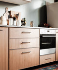 Modern kitchen with 30 Pack 4 Inch Satin Nickel Cabinet Pulls for kitchen cabinets, shown on wooden drawers and cabinets.