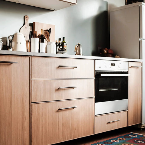 Modern kitchen with 30 Pack 4 Inch Satin Nickel Cabinet Pulls for kitchen cabinets, shown on wooden drawers and cabinets.