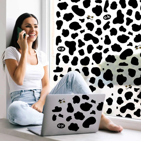 Woman working on laptop with Cow Print Stickers Set 600 Pcs Self Adhesive Wall Decals Waterproof Vinyl For Bathroom Nursery Bedroom Living Room Walls Easy Peel And Stick Dope Cow Themed Wall Art Vibes For Any Space on window.