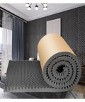High Density Pyramid Acoustic Foam Panels With Peel And Stick Application For A Badass Home Studio Sound Treatment That Squashes Echoes And Smooths Your Audio Vibes Totally Stress Free displayed in a modern room with a rolled foam mat.
