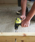 User drilling into wood with Compact Hammer Drill With Variable Speed Trigger And Reversal Built lightweight tool for home repair.
