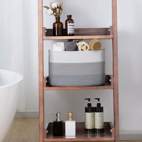 Grey decor woven rope storage basket on shelf, fits towels and accessories, part of the Woven Rope Storage Baskets Set Of 3 For Books Toys Towels And Magazines, Small Rectangle Organizer Bins For Bedroom Closet Living Room, 15 by 10 by 9 inches.