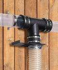 Hella Tough 4 To 3 Inch Dust Collection Reducer Flex Coupler With Steel Hose Clamps installed on a wooden wall.
