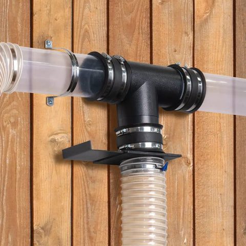 Hella Tough 4 To 3 Inch Dust Collection Reducer Flex Coupler With Steel Hose Clamps installed on a wooden wall.