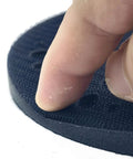 Close-up of a Durable Multi-Hole Sanding Buffer Pad 5.9 Inch showing finger pressing on sponge interface disc.
