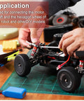 Beefy Four Piece 5mm To 5mm Universal Joint Shaft Couplings being installed on an RC car, showing practical application.