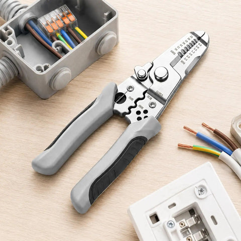 Compact Manual Wire Stripper Pliers Cutter And Gripper Tool 7.4 Inch positioned on a wooden surface with electrical wires.