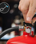 Hand holding fire extinguisher with iron cotter pins and plastic locks, 20 Piece Fire Extinguisher Pin And Tamper Seal Replacement Kit visible