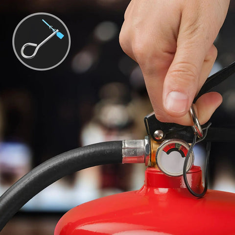 Hand holding fire extinguisher with iron cotter pins and plastic locks, 20 Piece Fire Extinguisher Pin And Tamper Seal Replacement Kit visible