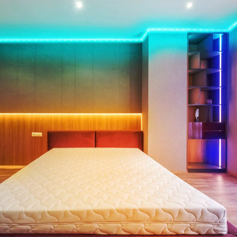 Bedroom with 100 Feet LED Light Strips for Bedroom With Color Changing LED Tape 44 Key Remote Two 50 Foot Rolls Multicolor Options 16 LED Modes 6 DIY Colors for Room Decor Mood Lighting Vibe installed around ceiling, emitting colorful ambient light.