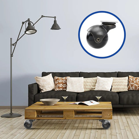 Top Shelf 2 Inch Antique Brass Swivel Casters With Heavy Duty Ball Bearings 4 Piece Furniture Wheel Set on a wooden coffee table.