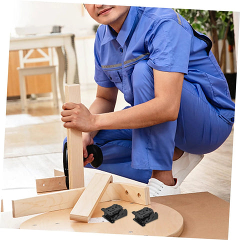 Man assembling furniture with space-saving folding hinge set for DIY projects.
