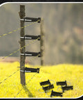 48 Pack Tube Post Insulators For Electric Fence Wire, T Post Insulators For Chain Link, Square Or Round Tubing, Black, Durable Plastic And Steel Construction, Weather Resistant, Perfect For DIY Fencing installed on wooden fence post.