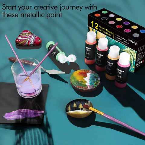 Set of metallic acrylic paint tubes, brushes, scraper, and painted stones with packaging. Metallic Acrylic Paint Set 12x60ml Professional Quality With 3 Free Brushes And 1 Scraper Non Fading Multi Surface Paints For Beginners And Pros Vibrant Metallic Colors For Arts And Crafts.