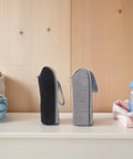 Legit Gotta Have 2 Piece Insulated Baby Bottle Carrier Tote With Stroller Hook in black and gray on a shelf.