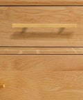 Close-up of Gold Kitchen Cabinet Door Pull Handles 128mm Metal Cabinet Hardware Set for drawers on wooden cabinet surface.