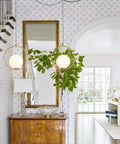 Plug In Globe Pendant Light Fixture With White Glass Ball And Brushed Brass Ring in a stylish living room setup