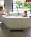 Mother and daughter in bathtub with visible 12 Inch Linear Shower Drain With Rectangular Floor Drain Grate Matte Black SUS304