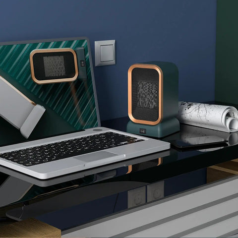 Portable Indoor Space Heater 1000 Watts High Output With Two Heat Settings, desk heater on black surface next to laptop