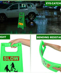 Kids At Play Safety Sign 24 Inches Green Pack Of 4 With Reflective Tapes Caution Slow Down For Street Kids And Pets At Play Yard Driveway Roadside Sign shown at night by a parked car.
