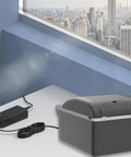 14.5 Volt Ac Dc Power Cord Kit For Portable Car Refrigerator Freezer Cooler with power adapter on a table near a window.
