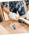 Carpenter working with a mallet on wood, showcasing a Stainless Steel Groove Wheel Pulley for Sliding Doors and Barn Doors in foreground.