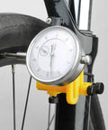 Close-up of Pro Grade Wheel Turning Stand With Dial Indicator for precise bike wheel alignment and repair at home, black.