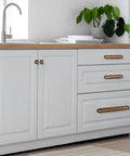 Kitchen cabinet with solid brass and wood cabinet pulls, five-pack, three and three-quarter inch center to center dresser drawer handles.