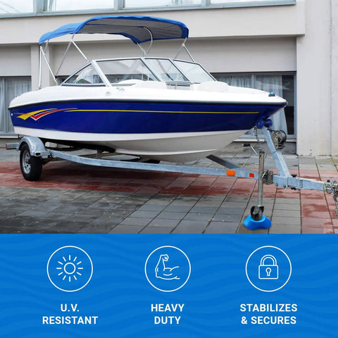 Blue and white boat on trailer with Two Trailer Wheel Chocks With Rope And Wheel Dock For Boat Trailers Travel Campers And RV Accessories Keeps Wheels From Rolling On All Trailer Tires And Easy No Hassle Setup Anywhere visible on pavement.