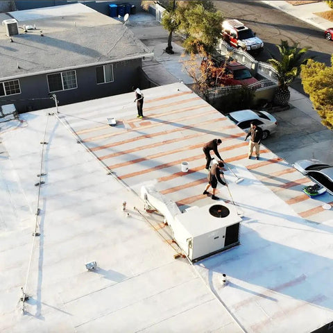 Workers applying Heavy Duty Liquid Waterproofing Membrane Multi Surface Crack And Leak Repair Coating Interior Exterior Water Based Moisture Blocker Heavy Duty Sealant Easy Brush Application 5 Gallon Sandy Beige on roof.