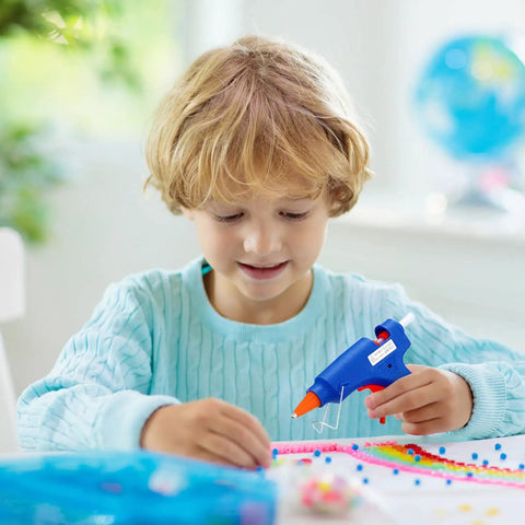 Child using 4 Piece Mini Hot Glue Gun Set With 20 Glue Sticks For Kids Projects Low Temp Kid Friendly Easy To Use Drip Proof Nozzle Rubber Protector Ideal For Arts And Crafts Sealing DIY Projects And Everyday Home Repairs